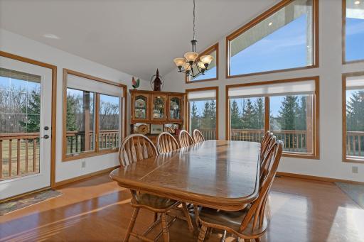 Dining area with lots of gathering space, including access to the wraparound deck.