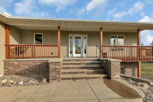 Step into your own private oasis with this charming front porch area. The spacious porch offers ample space for outdoor seating. The inviting ambiance of the porch area is perfect for relaxing with a book.