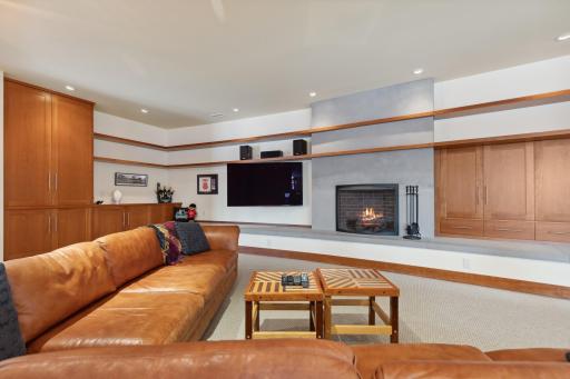 Media Room Features Cherry Built-Ins, Curved Limestone Hearth and Masonry Fireplace