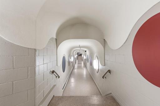 The tunnel to the various fitness, pool and court amenities.