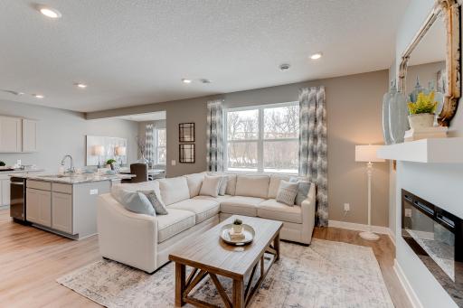 Another look at the main level family room, which flows conveniently with the rest of the space provided in this charming layout! (Photos of the same floorplan, colors are similar)