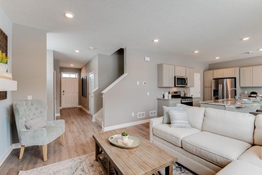 Another look at the main level family room, which flows conveniently with the rest of the space provided in this charming layout! (Photos of the same floorplan, colors are similar)