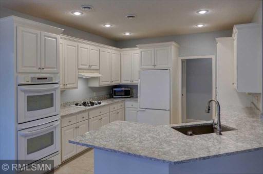 Bright kitchen with full appliances and Cambria tops.