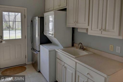 Near the kitchen, the laundry room has an extra refrigerator and the owner's entrance.
