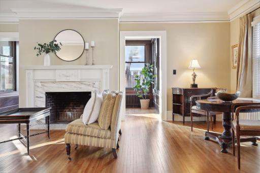 Lovely sitting room with a wood burning fireplace adds wonderful ambiance to this large room
