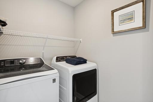Centrally located on the upper level, along with the four bedrooms, this laundry room is sure to provide the ultimate convenience. (Photo of decorated model, actual home's finishes may vary slightly)