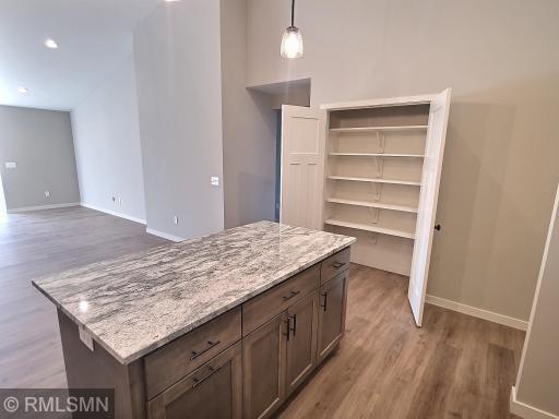 The walk in pantry is just off the center island. Plenty of shelf space for all your kitchen goods.