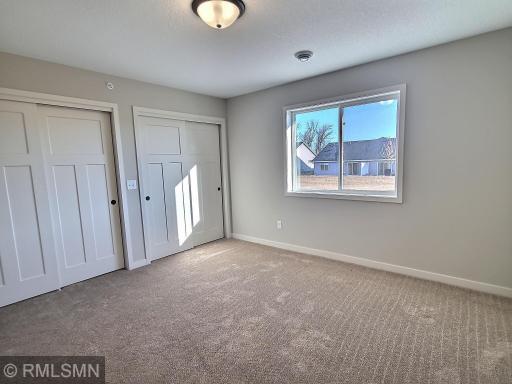 Spacious primary bedroom with dual closets and private bath.