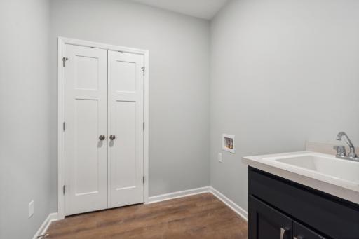 The laundry room provides hookups for a washer/dryer along with a utility sink.