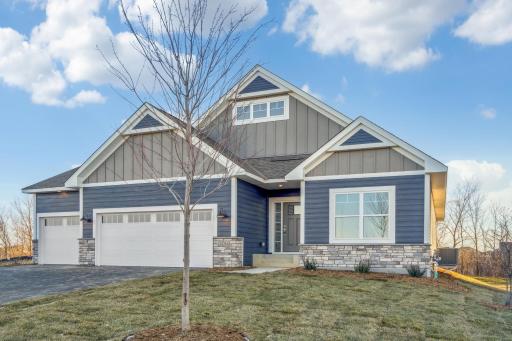 The upgraded exterior elevation showcases james hardie siding and brick accents.