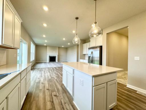Enjoy plenty of seating at the kitchen island and dining area adjacent to the kitchen. Perfect for entertaining or having a family meal together. Photos of similar home, actual colors and finishes may vary.