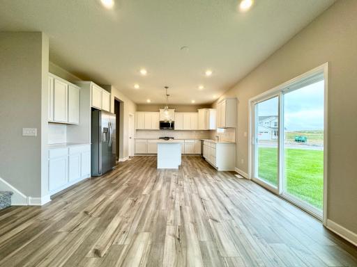 This spacious and open-concept main level allows for optimal versatility and comfort. Photos of similar home, actual colors and finishes may vary.