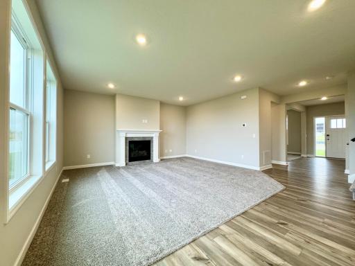 The main level seamlessly transitions from room to room while maintaining an open-concept layout throughout. Photos of similar home, actual colors and finishes may vary.