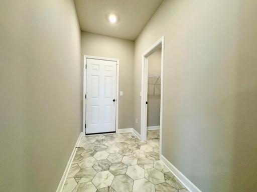 The garage entry of the Lewis with walk-in storage closet. Photos of similar home, actual colors and finishes may vary.