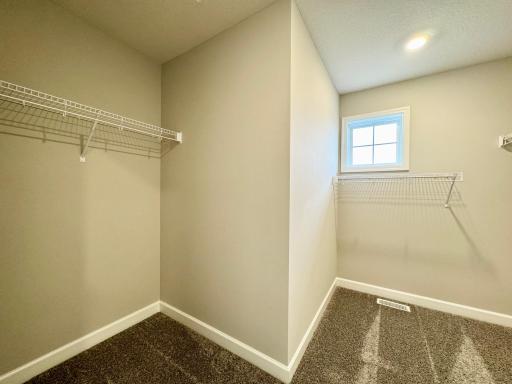 The owner's suite features an incredible walk-in closet. Photos of similar home, actual colors and finishes may vary.