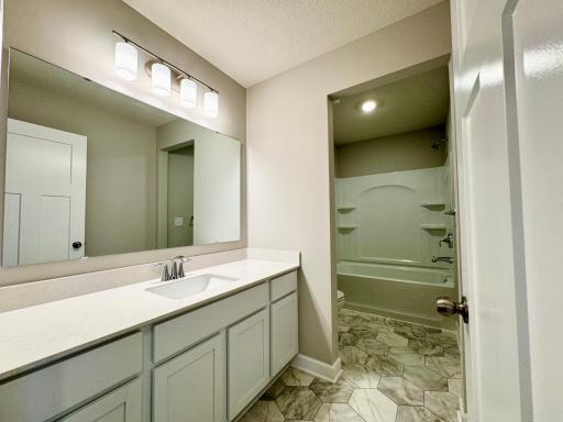 Upper level hall bath. Photos of similar home, actual colors and finishes may vary.