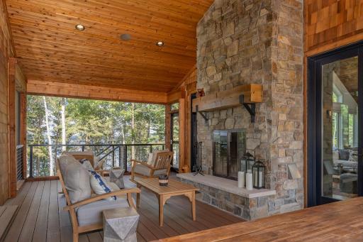 Enjoy the screen porch with wood burning fireplace with direct access to both the lake side deck and back deck and covered porch..jpg