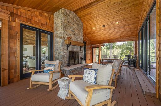 A screened porch and stone, wood burning fireplace topped with a vaulted pine ceiling brings relaxation, while enjoying the outdoors..jpg