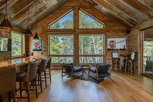 Enjoy game time from the bar above the garage and off the screen porch area..jpg