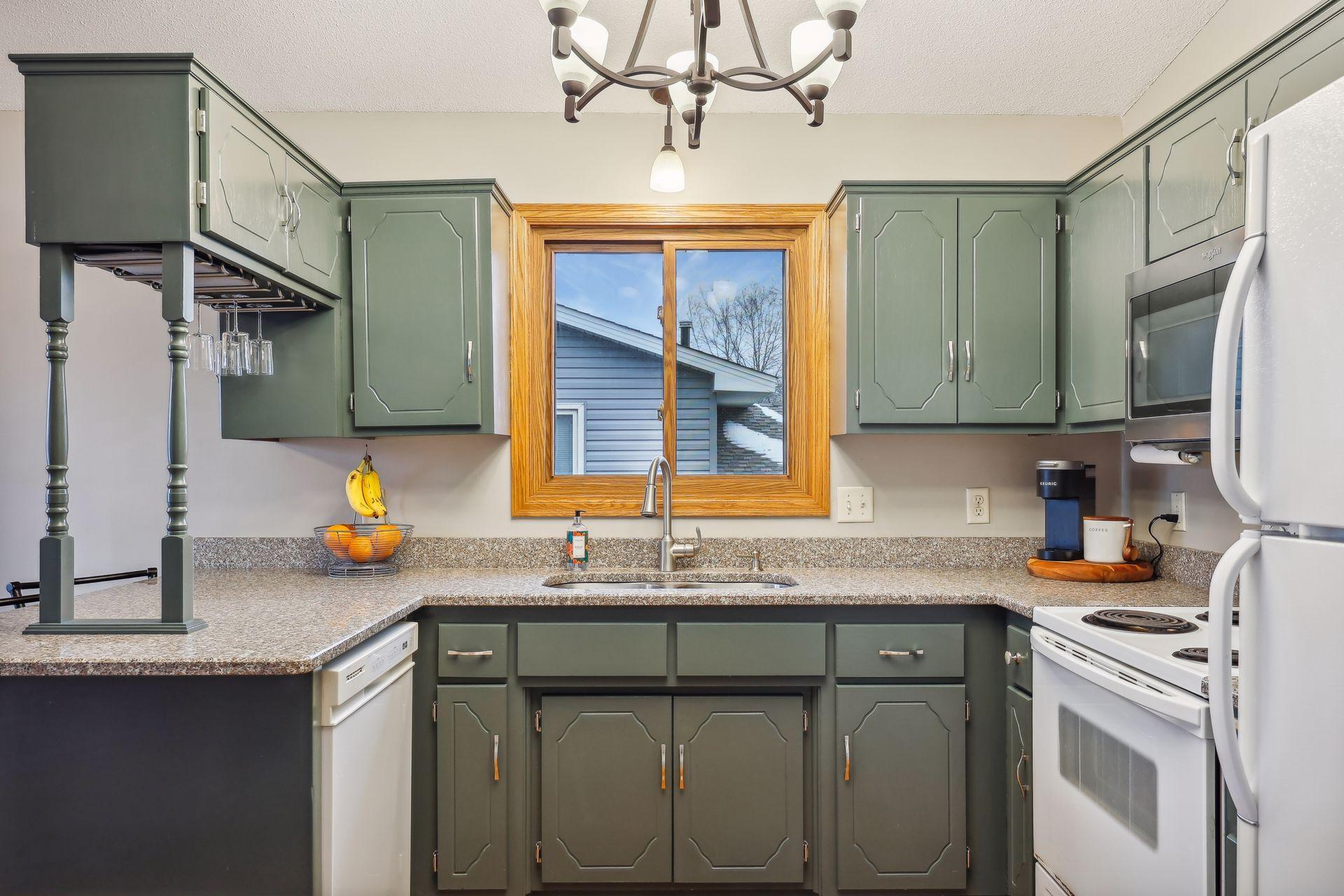 Granite countertops and enameled cabinets.