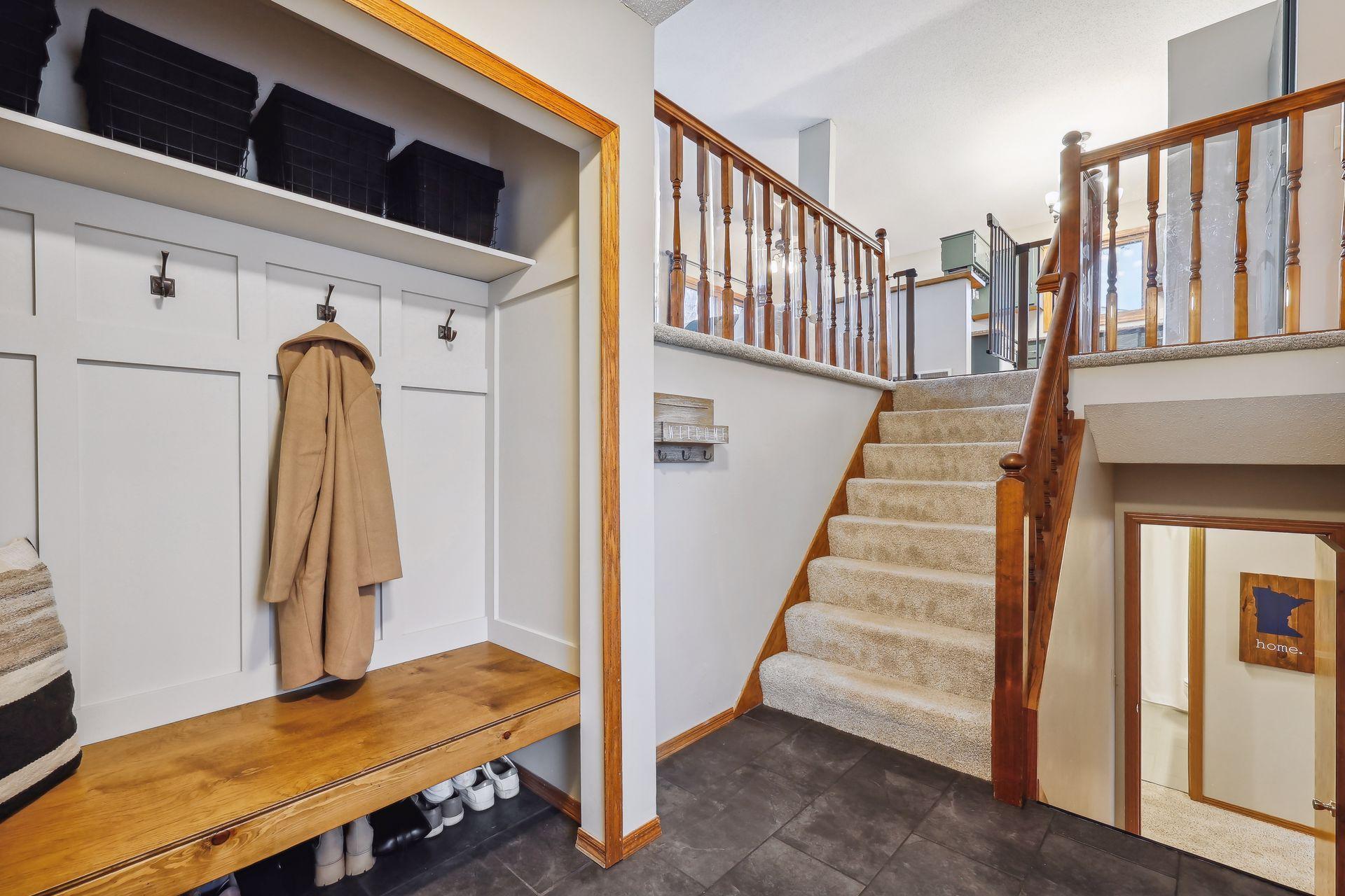 Nice size foyer with new tile flooring and custom built -in bench with wainscoting.
