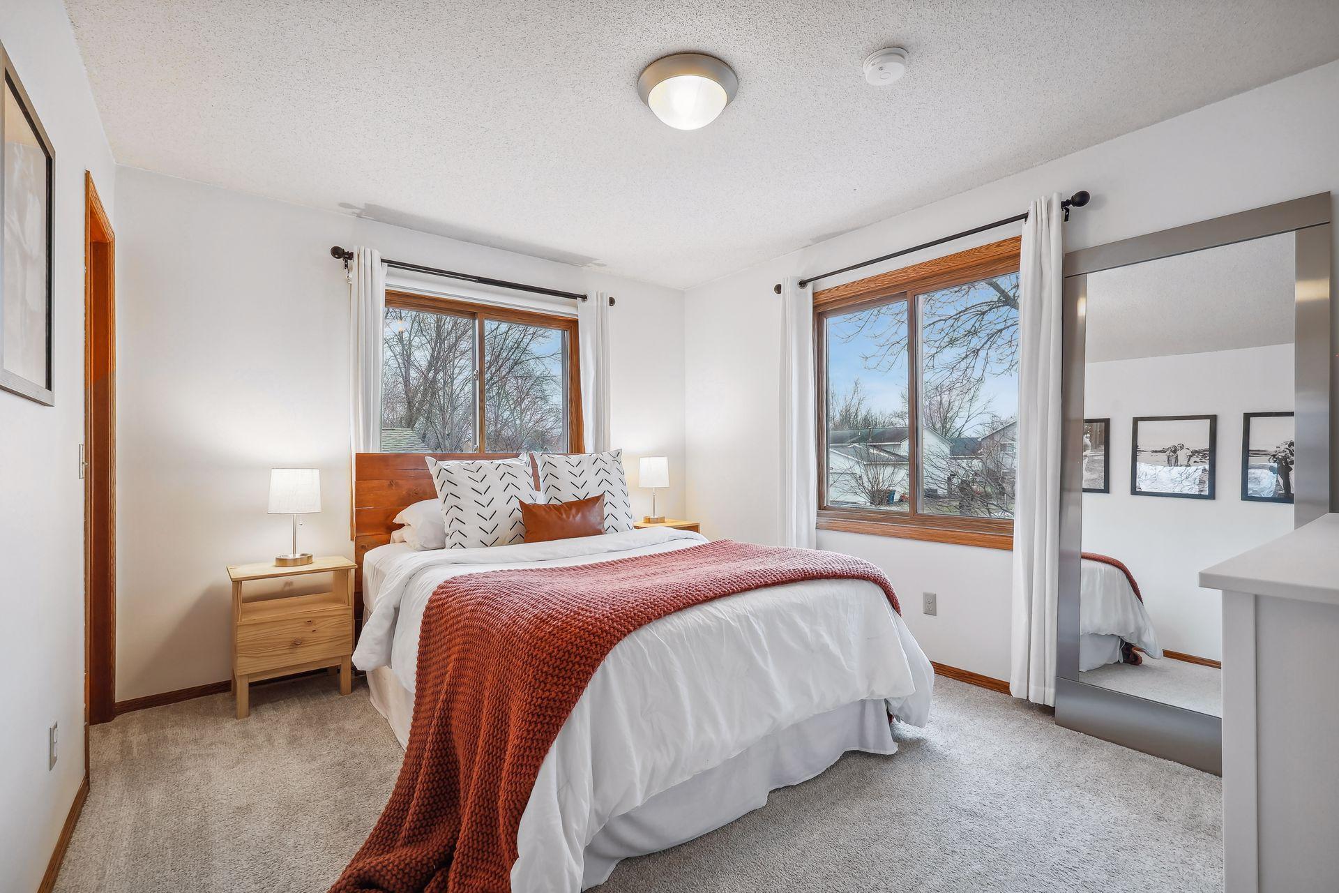 Primary bedroom with lots of natural light and a walk-in closet.