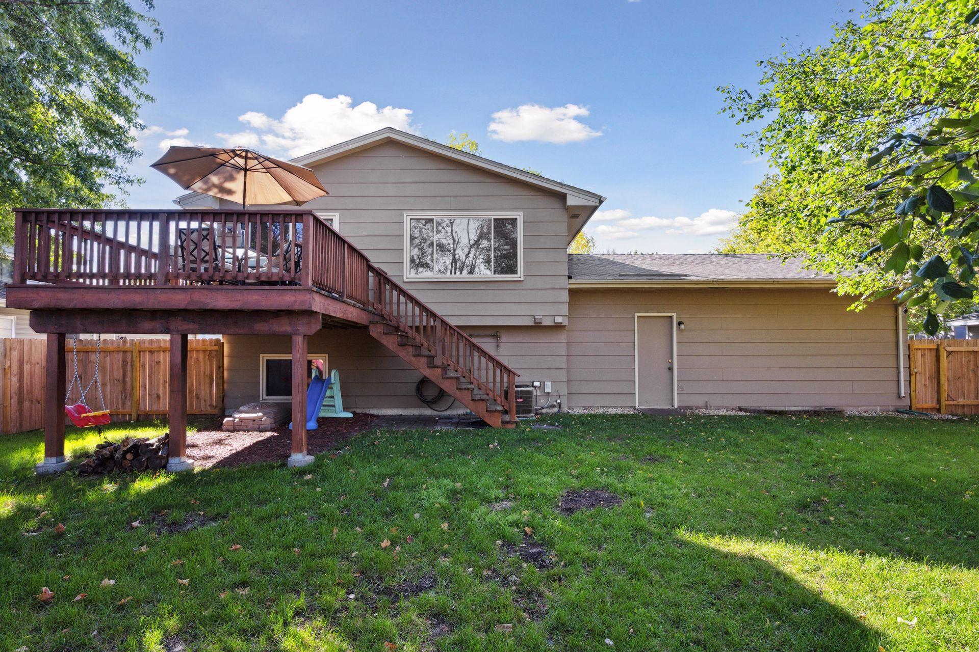 Deck with stairs to lead you out to large flat backyard.