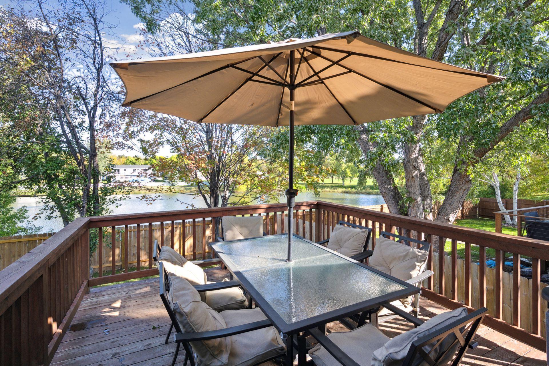 Large deck to enjoy the beautiful backyard and views of the pond.