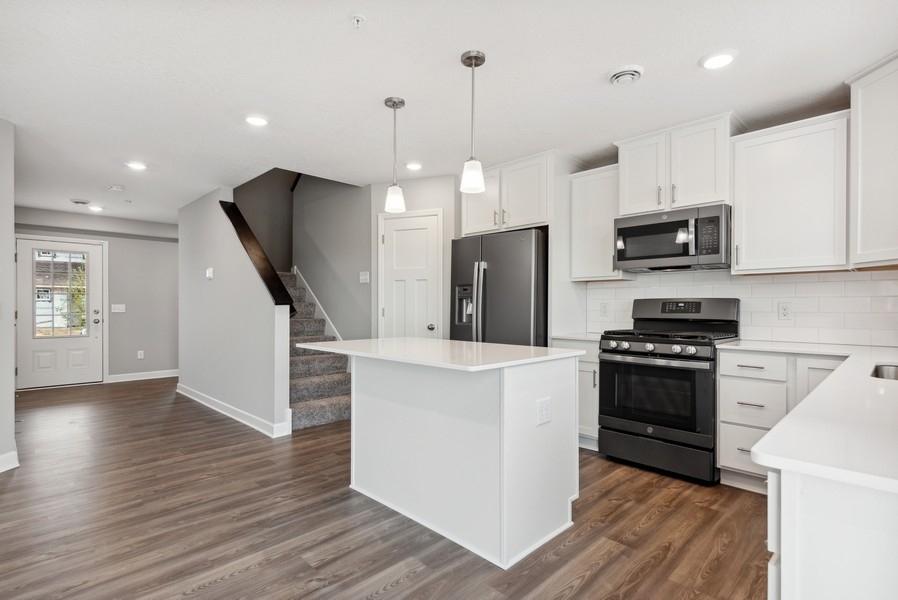 The spacious and open-concept main level allows for optimal versatility and comfort. (Photo of a completed home, actual home's finishes may vary slightly)