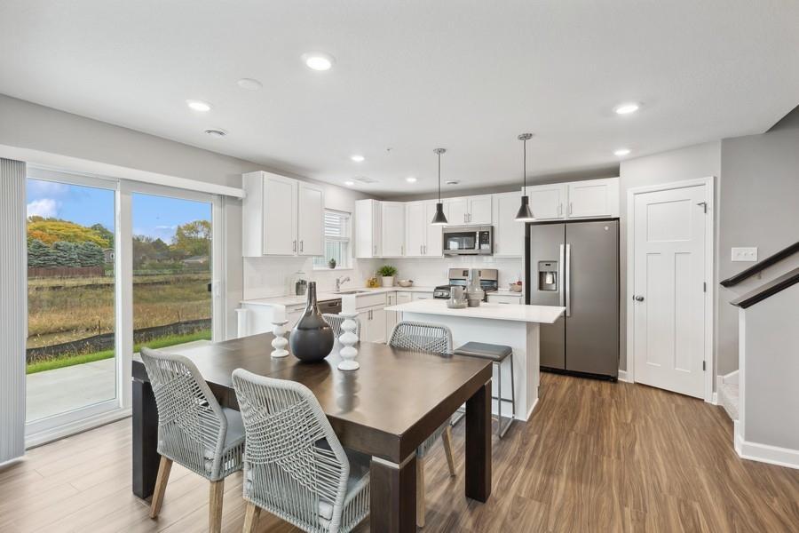 Soaked in natural sunlight, the homes eat-in dining room has ample space for a dining table located in the heart of the home. (Photo of decorated model, actual home's finishes may vary slightly)