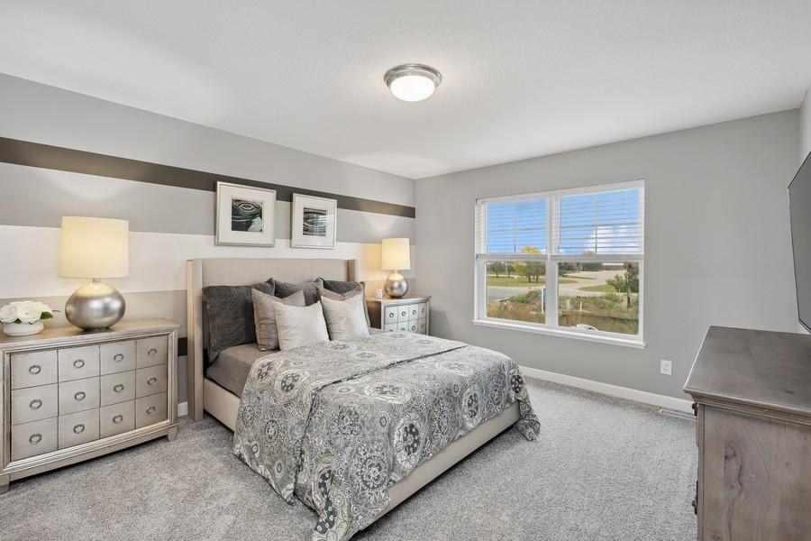 Find your retreat in this stunning owner's suite. Enjoy the exclusivity of a private bath and huge walk-in closet. (Photo of decorated model, actual home's finishes may vary slightly)