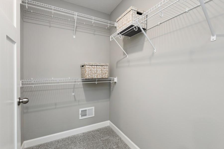 The owner's suite features an incredible walk-in closet. (Photo of decorated model, actual home's finishes may vary slightly)