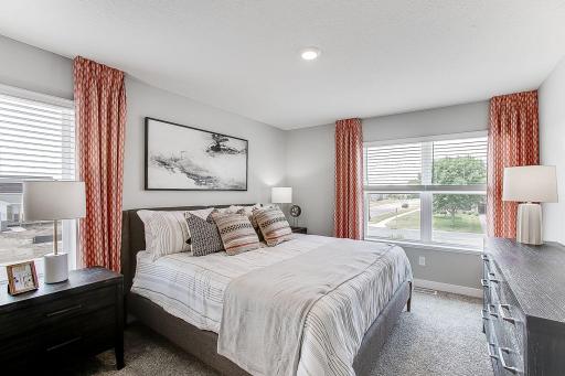 The main bedroom has extra windows for great lighting! *Photos of model home, colors and selections may vary.