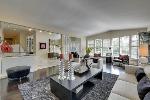 Elegant living room with vault ceiling and bow shaped front window wall