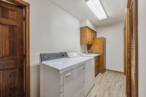 Laundry area also has solo tube and built in cabinets and closet for coats.