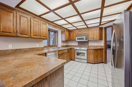 Kitchen has tiled floor, Stainless appliances, and ample room for multiple chefs.