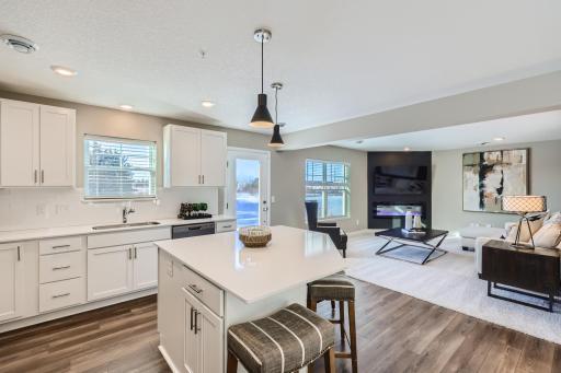 The kitchen seamlessly transitions into the Great Room. (Photo of decorated model, actual home finishes may vary slightly)