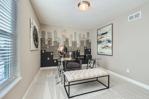Located just off the foyer, this main level flex room provides endless opportunities; including a home office, formal dining area, an extra playroom or another sitting room. (Photo of decorated model, actual home finishes may vary slightly)