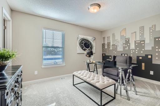 Another view of the spacious main level flex room. (Photo of decorated model, actual home finishes may vary slightly)