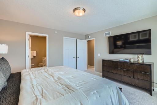 Another view of the spacious owner's suite with a view of the private bath. (Photo of decorated model, actual home finishes may vary slightly)