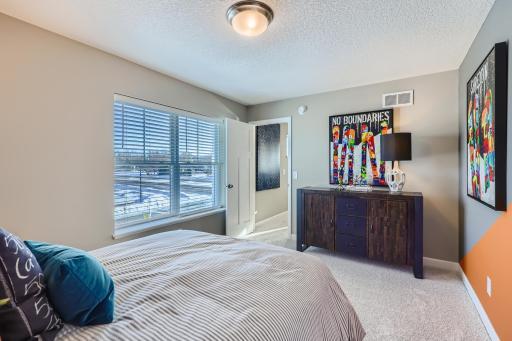 Another view of one of the spacious secondary bedrooms. (Photo of decorated model, actual home finishes may vary slightly)