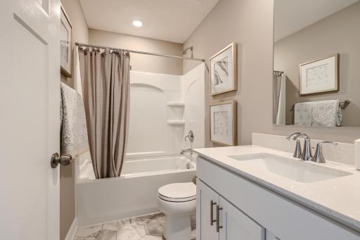 The home's secondary bath provides plenty of space for everyone to get ready during those busy mornings. (Photo of decorated model, actual home finishes may vary slightly)