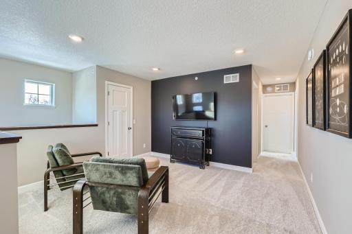 Located on the upper level, this perfectly sized loft space has enough room for a desk, television and seating for all. (Photo of decorated model, actual home finishes may vary slightly)