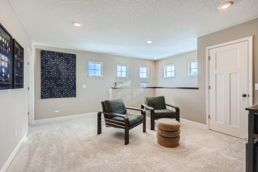 Another view of the spacious upper level loft area. (Photo of decorated model, actual home finishes may vary slightly)