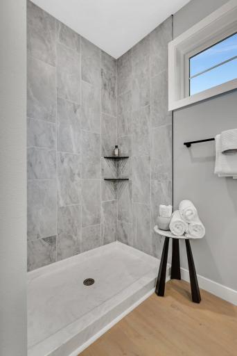 ...free standing shower with tile, glass shower door and...
