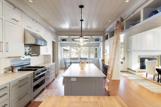 A closer look reveals the rolling ladder to access high cupboards and shelves.