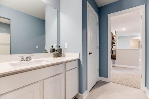 Those bedrooms each have easy access to this deep and spacious bathroom! Photo of model home, color & options may vary.