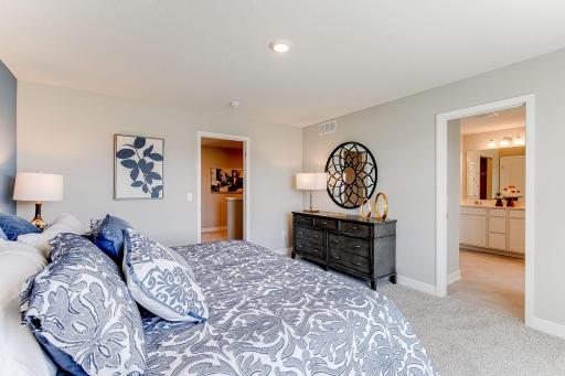 A second view of the Primary Suite. Shown here with a King-sized bed, the room is overly spacious and offers the perfect setting to start and finish each day in! Photo of model home, color & options may vary.