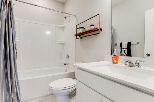 A peak inside the main level full bathroom! Photo of model home, color & options may vary.