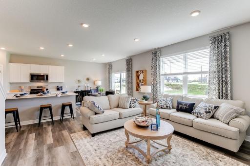 The open feel extends into to the main level family area - which is every bit as inviting and it is beautiful! Photo of model home, color & options may vary.